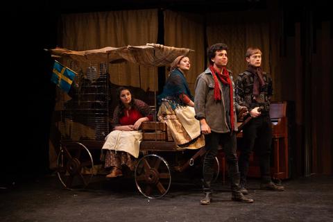 Actors on stage in a scene from Mother Courage